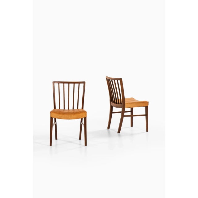 Rare set of 8 dining chairs designed by Frits Henningsen. Produced by cabinetmaker Frits Henningsen in Denmark. This piece...