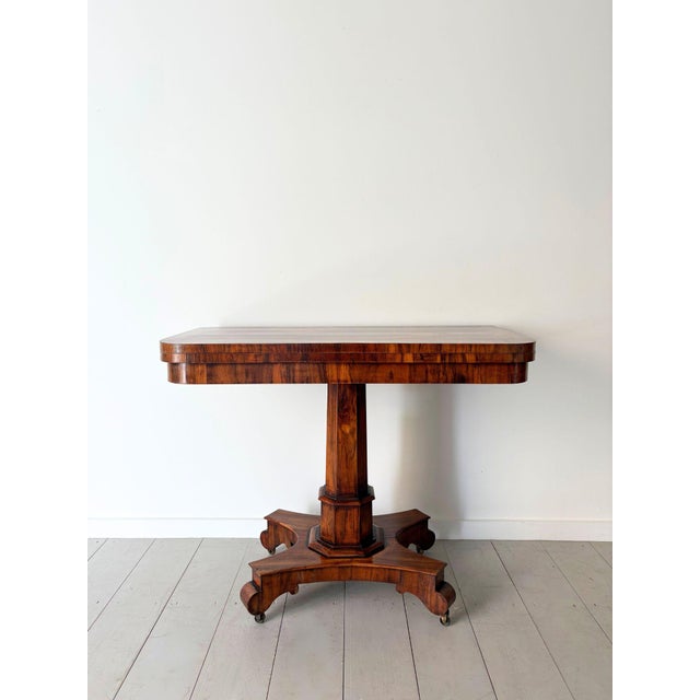 A fine antique fold over card table of elegant proportions, in figured rosewood veneer with cross banded edges. This...