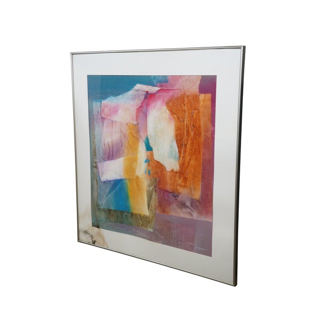 Late 20th century work of brightly colored abstract art by Tom Anderson. Silver tone metal frame; white mat. Framed in...
