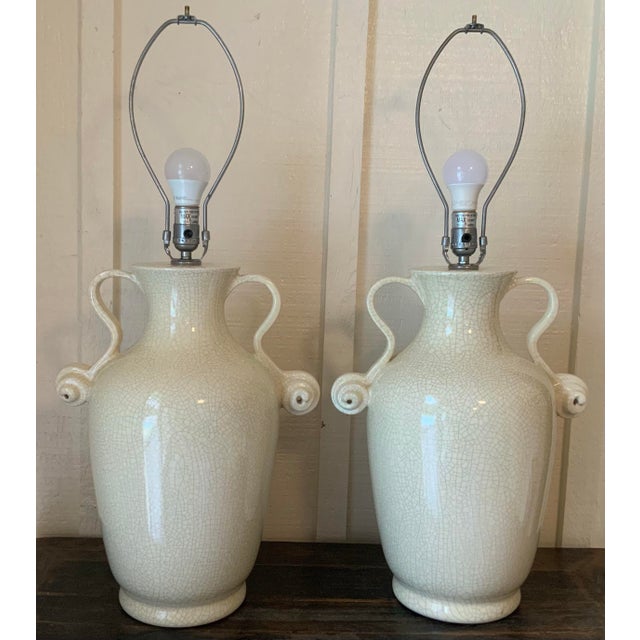 A sophisticated pair of oversized crackle‑glazed ceramic urn lamps, perfect for designers seeking scale and symmetry. Each...