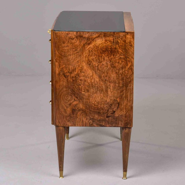 An elegant Italian chest of drawers veneered in richly figured burl walnut with spectacular swirling grain throughout,...