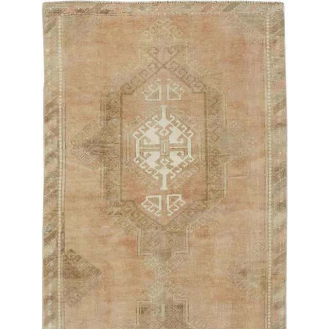 This mid-20th-century Turkish Anatolian runner presents a restrained sequence of three large geometric medallions arranged...