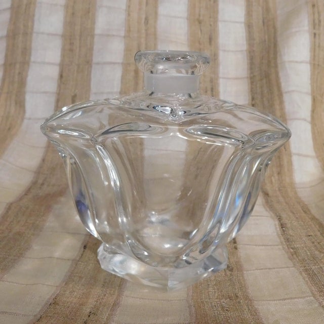 This is a tulip shaped crystal perfume bottle with a matching stopper. It has no tags or markings and I believe the bottle...