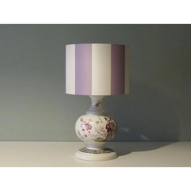 The lamp base has an attractive Oriental-inspired drawing of Japanese cherry tree and a lovely scene of geishas. The table...