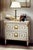 Handcrafted in Italy, this Louis XVI nightstand features a glazed white finish accented with 24-karat gold leaf detailing....