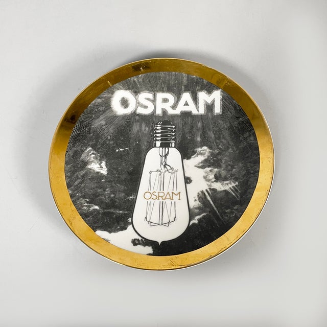 Italian modern decorative plate Osram by Fornasetti, 1970s Decorative plate model Osram 1912, from the Lampade D'Epoca...