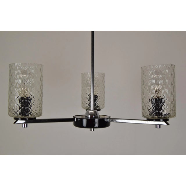 Made in czechoslovakia made of glass, chrome, lacquered metal with aged patina(see foto) 3x40w,e27 or e26 bulb re-polished...