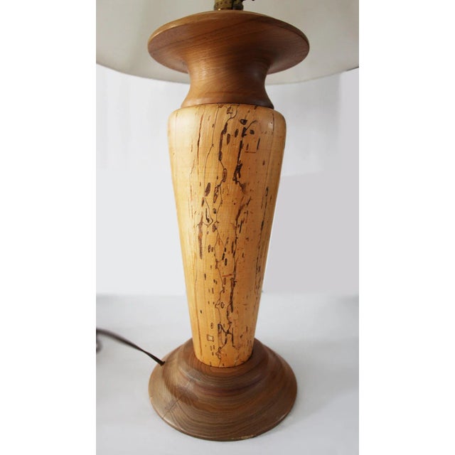 Vintage rustic hand made wooden table lamp. Hand turned wood. The lamp has a vertical crack along the back side and is...