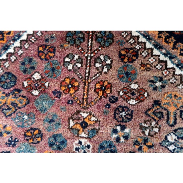 Introduce a touch of history and artistry into your space with our Antique Persian Shiraz Rug from the 1940s. This...