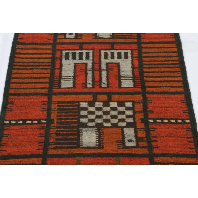 Hand-knotted in lush, high-pile wool in Sweden circa 1960-1970, this 2x5 vintage Swedish Rya runner rug is a bold new...