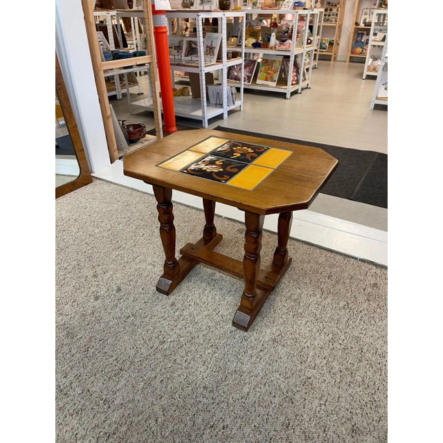 Vintage Catalina Style Accent Table with 6 Yellow and Black Colored Tiles. Turned Legs with stretcher. Makers Mark on the...