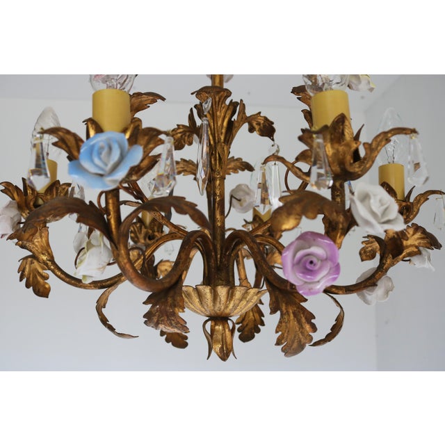 Stunning Mid-Century Italian tôle chandelier from the 1950s, beautifully handcrafted with colorful ceramic roses, gold-...
