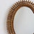 Italian rattan oval-shaped wall mirror (circa 1960s). A distinctive vintage mirror which transports you immediately to...