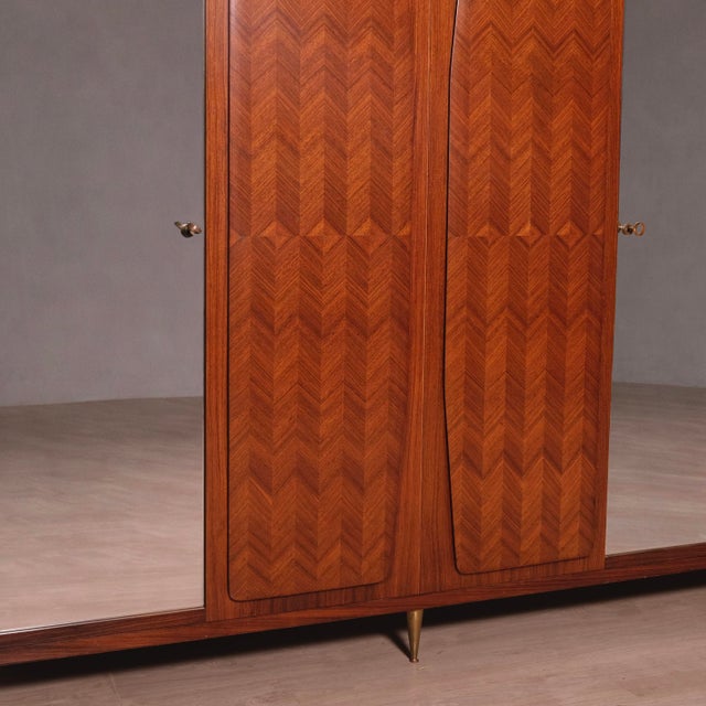 Beautiful wardrobe, originally designed and produced in the 1950s, attributable to Vittorio Dassi. It features 6 doors, 3...