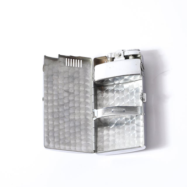 This exceptional Art Deco cigarette case & lighter, crafted by Ronson in America, circa 1935, exudes the sleek...