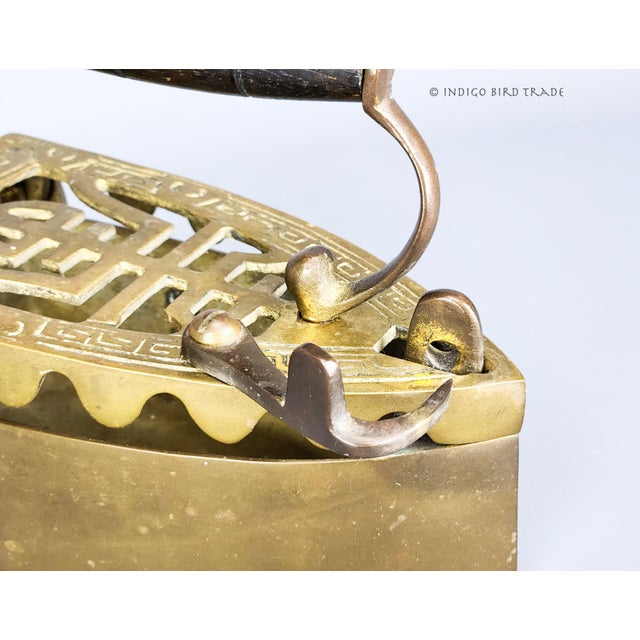 Antique Brass Sad Iron with Wooden Handle This beautiful sad iron is made from solid brass with wooden handle. The hinged...