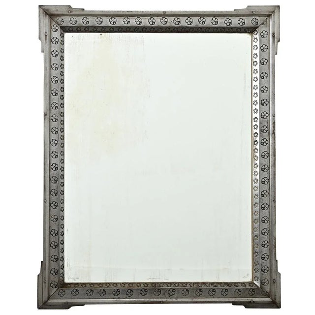 An unusual French mirror from the early 20th century, made of a steel frame that is embossed with four-leaf clover icons...