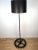 Pair of heavy industrial iron gear floor lamps. One-of-a-kind repurposed gear base and iron body. Black powder-coated...