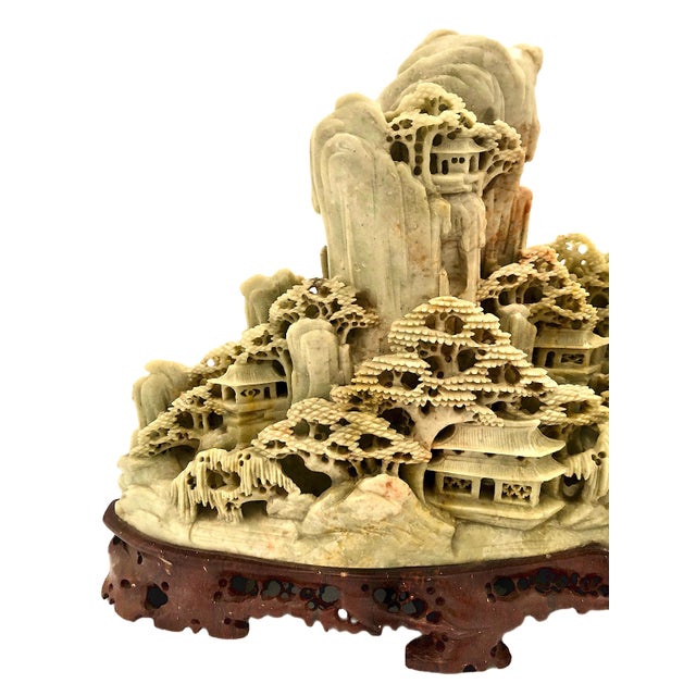 On offer is an intricate Chinese soapstone landscape carving depicting a serene mountain village. The carving depicts a...