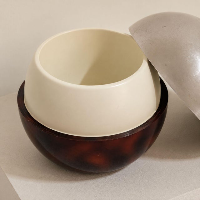 Elegant French ice bucket crafted in metal with bakelite details, a refined vintage bar accessory with strong Mid-Century...