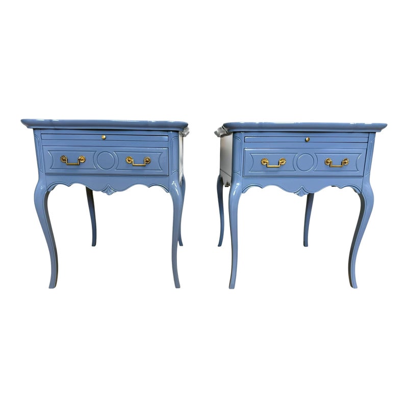 Two blue nightstands with gold hardware