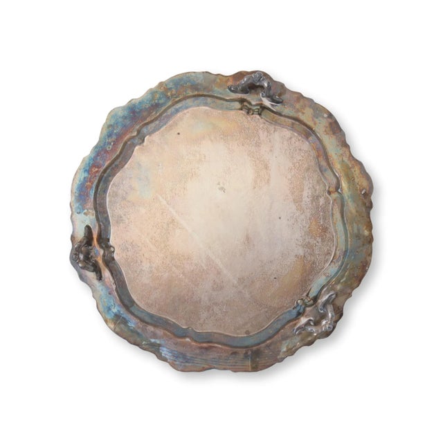 This distinctive silver-plated tray is a testament to the beauty of age, showcasing a one-of-a-kind oxidized color that...