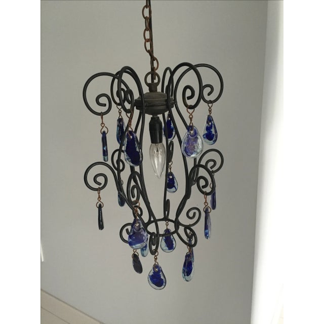 Sapphire blue murano glass teardrop pendant on a blackened iron frame purchased from Greece. It's the perfect splash of...