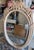Beautiful vintage 1970s/1980s Hollywood Regency oval wall mirror. Features a heavy, durable molded resin/composite frame...