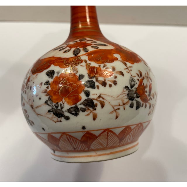 Antique Japanese Kutani vase or bottle with maroon or burnt orange floral decoration. Marked on the bottom with a body...