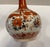 Antique Japanese Kutani vase or bottle with maroon or burnt orange floral decoration. Marked on the bottom with a body...