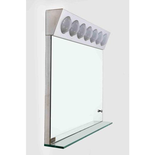 Seven-light wall mirror in aluminum, acrylic glass, and glass. Fontana Arte label. Italy, 1970s. Very good condition,...