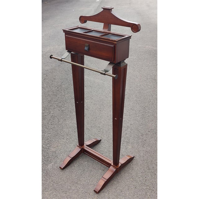 Men's valet stand with sectioned top and front drawer designed to hold and organize a gentleman's suit and accessories,...
