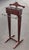 Men's valet stand with sectioned top and front drawer designed to hold and organize a gentleman's suit and accessories,...