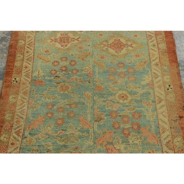 Hand-knotted in wool circa 1890-1900, this 3x9 antique Persian Sultanabad runner is a gorgeous and evocative fragment from...
