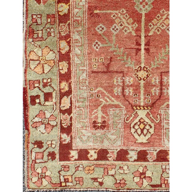Tribal Antique Oushak Rug From Turkey With Directional Tribal Motifs in Soft Rose Red & Green For Sale - Image 3 of 7
