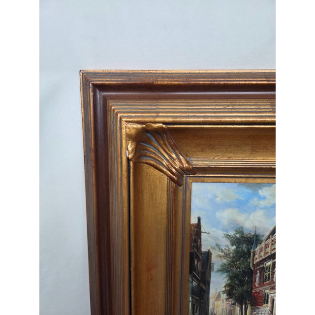 This vintage oil painting on board captures a charming Old World European street scene, rich with architectural detail and...