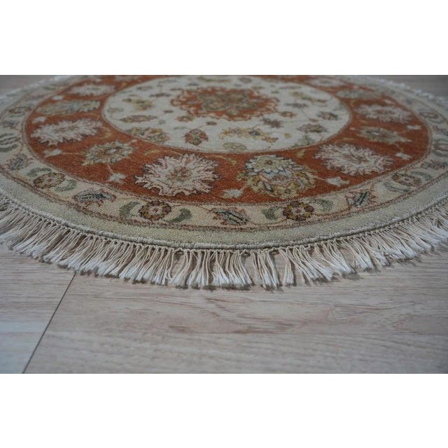 This ivory beige cream white wool rug features a traditional Agra style. It is constructed with a hand knotted pile weave...