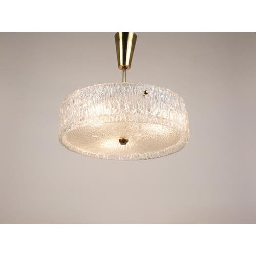 This is a beautiful Mid-Century Modern glass and brass chandelier / pendant light from the 1950s, crafted by J.T. Kalmar...