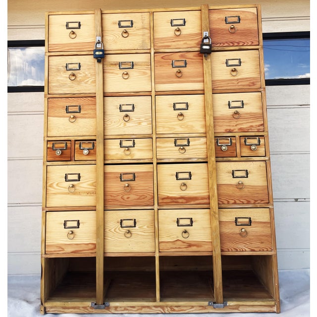 An exceptional, original card catalog cabinet from the mid-20th century, crafted from solid pine (with plywood back panels...