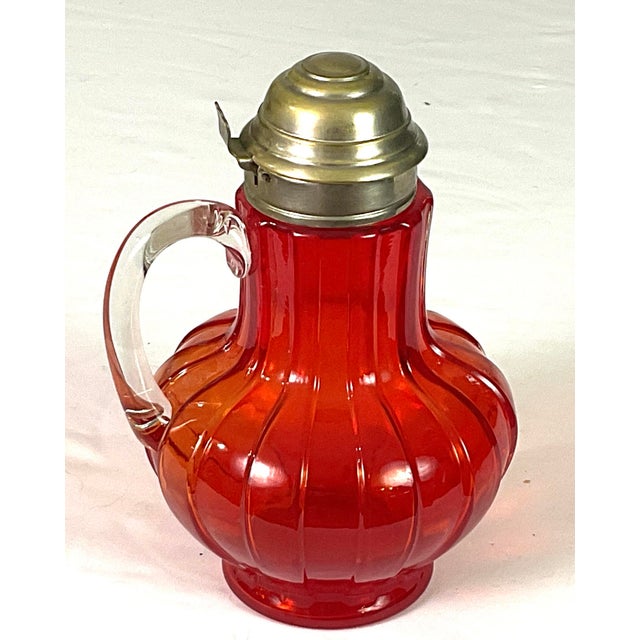 Consolidated glass – pigeon blood-EAPG-syrup pitcher-with a pewter lid and spout Marked on the lid – patent pending...