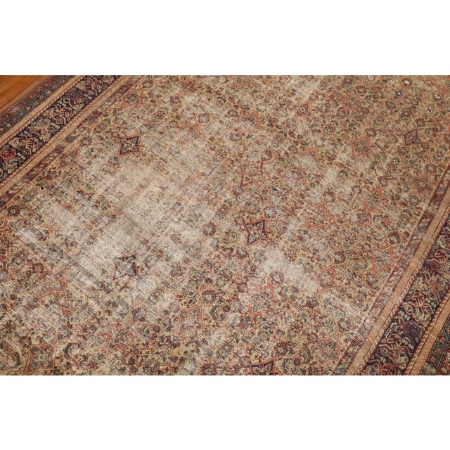An early 20th century worn Persian Fereghan Rug