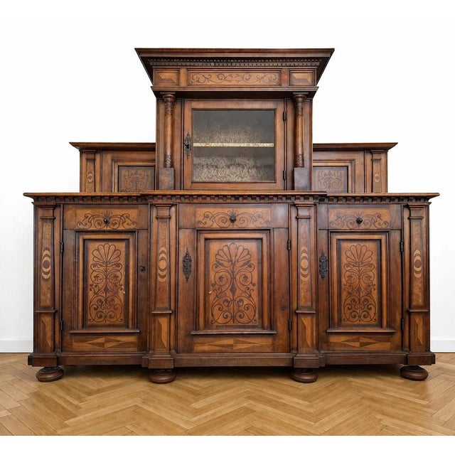 An important, richly ornamented two-part walnut buffet from the Renaissance/17th century, showcasing remarkable marquetry...