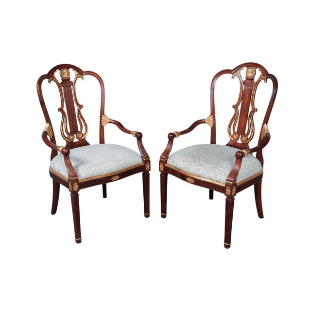 A pair of reproduction English Regency style armchairs in mahogany by Jonathan Charles for their Buckingham, collection....
