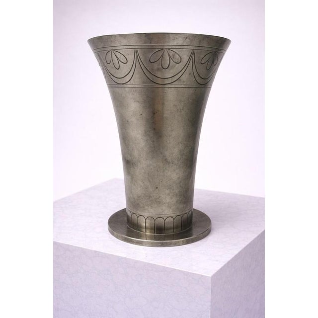 A striking swedish art deco pewter vase by renowned silversmith cg hallberg, dating to the early 1930s. This elegant piece...