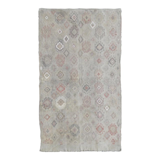 Mid 20th Century Vintage Turkish Kilim Featuring Muted Colors and All-Over Tribal Motif Design For Sale