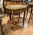 A stunning French Louis XV-style oval side table showcasing exceptional marquetry craftsmanship, elegant proportions, and...