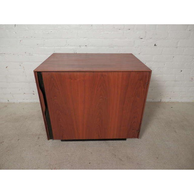 Super vintage single door cabinet with inside magazine rack, shelf, and pull out formica tray table. Designed by John...