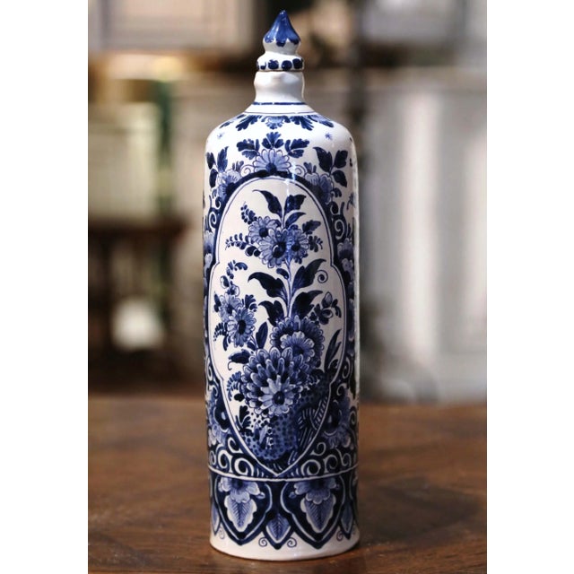 Decorate a shelf or kitchen counter with this elegant antique Delft olive oil container. Crafted in Holland circa 1940,...