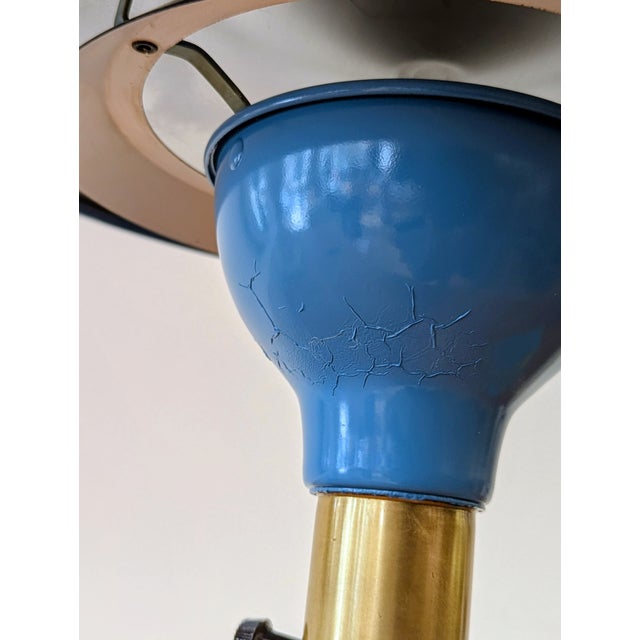 American desk lamp by M.G. Wheeler featuring blue enameled aluminum shade and base with brass articulated arm. Designed...