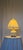 Elegant matching pair of vintage porcelain table lamps featuring softly rounded ivory-colored bodies adorned with delicate...